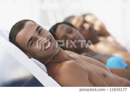 Hispanic man sunbathing 11630177