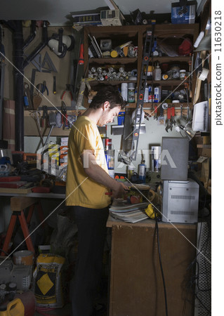 Middle Eastern man in home workshop 11630218