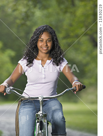 Teenage girl riding a bike 11630219