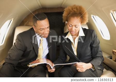 African American businesspeople on airplane 11630313