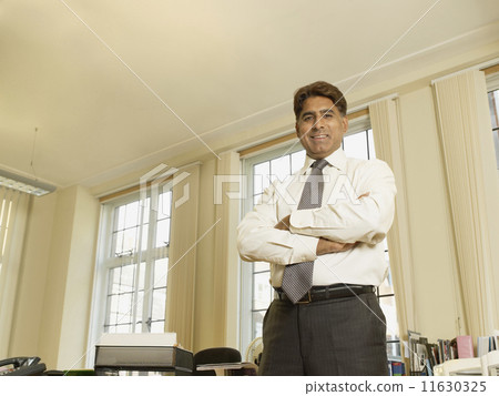 Indian businessman with arms crossed Indian businessman with arms crossed 11630325