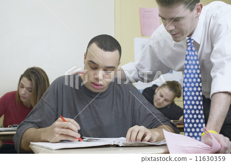 Teacher and students in classroom 11630359