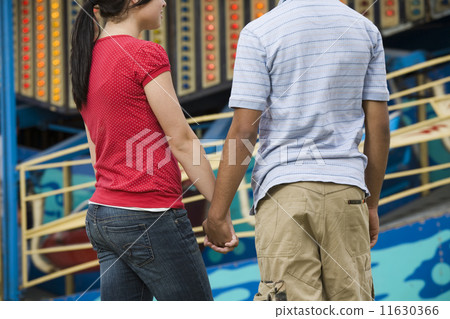 Multi-ethnic teenaged couple holding hands Multi-ethnic teenaged couple holding hands 11630366