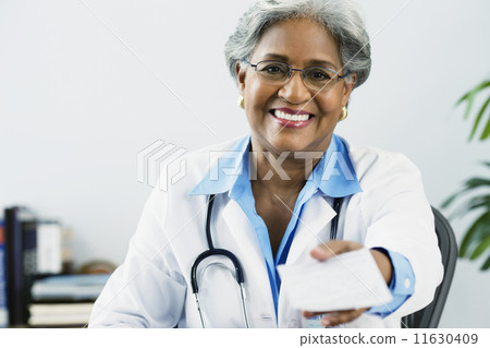 African female doctor holding a prescription African female doctor holding a prescription 11630409