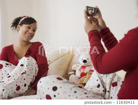 African twin sisters taking photograph 11630411