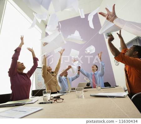 Businesspeople cheering at meeting 11630434