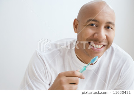 Portrait of Indian man brushing teeth 11630451