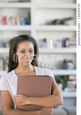 African American woman holding folders African American woman holding folders 11630459
