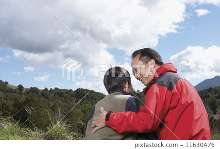 Asian father and son hugging outdoors Asian father and son hugging outdoors 11630476