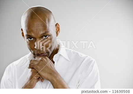 African man resting chin on hands 11630508