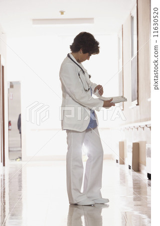 Female doctor looking through her notes 11630520