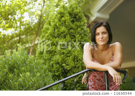 Young woman leaning on railing 11630544
