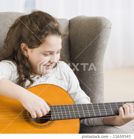 Hispanic girl playing guitar Hispanic girl playing guitar 11630545