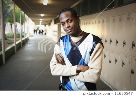 African teenage boy standing in school hallway African teenage boy standing in school hallway 11630547