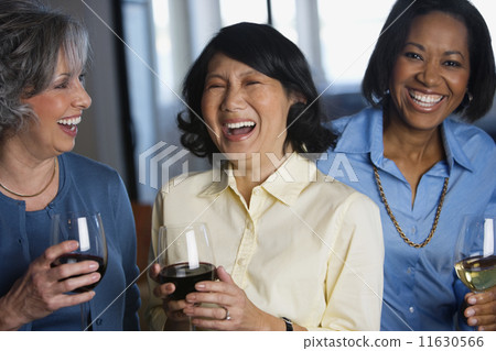 Multi-ethnic women drinking wine 11630566