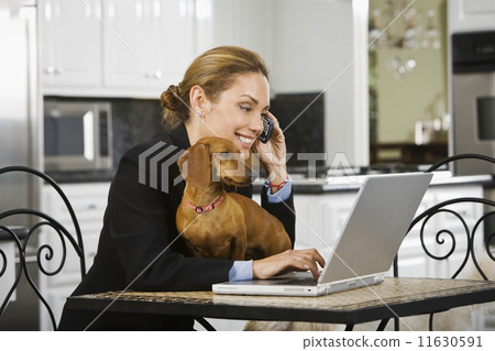 Hispanic businesswoman talking on cell phone Hispanic businesswoman talking on cell phone 11630591