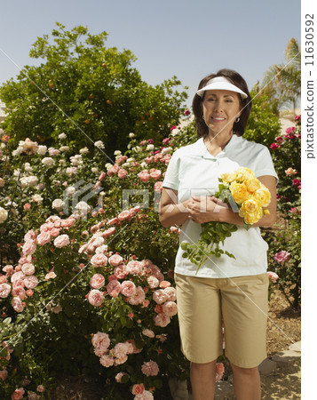Hispanic woman gardening Hispanic woman gardening 11630592