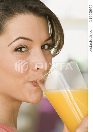 Woman drinking orange juice 11630643