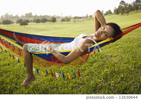 African woman laying in hammock smiling African woman laying in hammock smiling 11630644