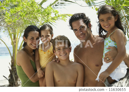 Hispanic family hugging at beach Hispanic family hugging at beach 11630655