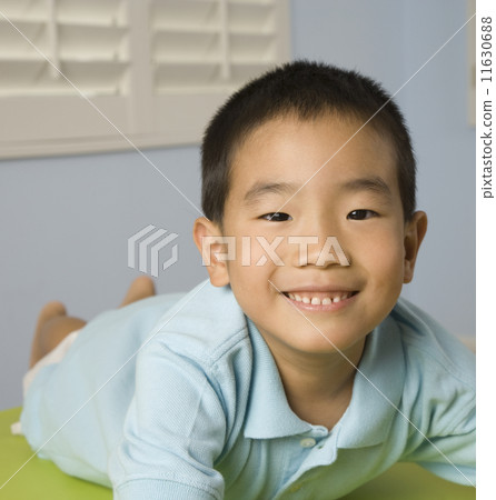 Asian boy laying on table 11630688