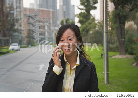 Asian businesswoman talking on cell phone Asian businesswoman talking on cell phone 11630692