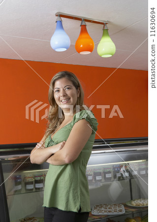 Hispanic female business owner in gourmet food store 11630694