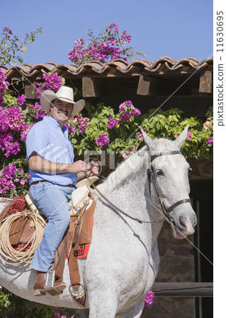 Hispanic man riding horse Hispanic man riding horse 11630695