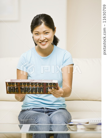 Asian woman holding abacus 11630709