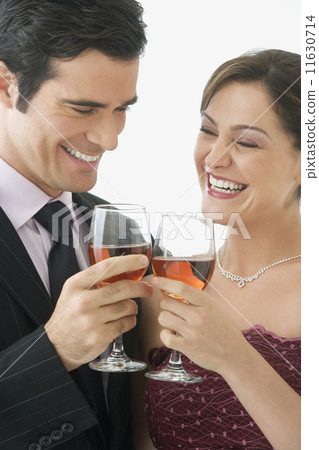 Studio shot of couple toasting with wine glasses Studio shot of couple toasting with wine glasses 11630714