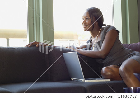 African businesswoman sitting on sofa African businesswoman sitting on sofa 11630718