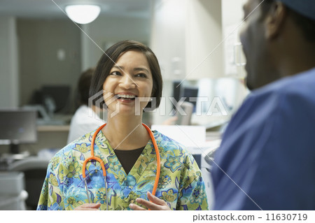 Female nurse talking to co-worker Female nurse talking to co-worker 11630719