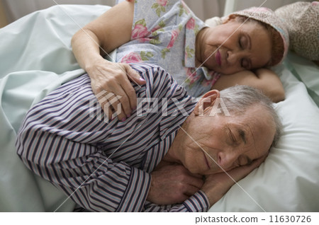 Elderly couple asleep in bed Elderly couple asleep in bed 11630726