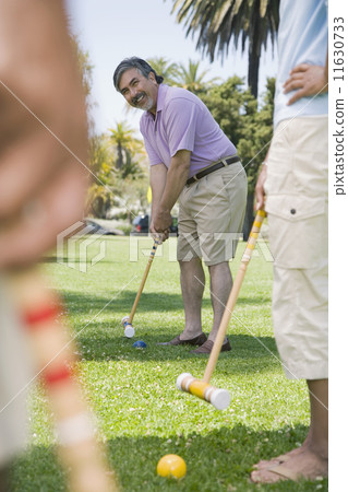 Hispanic man playing croquet 11630733