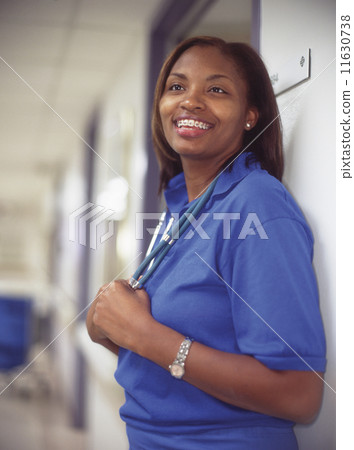 Female doctor in hospital hallway Female doctor in hospital hallway 11630738