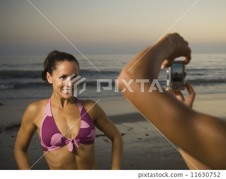 Hispanic woman having photograph taken 11630752