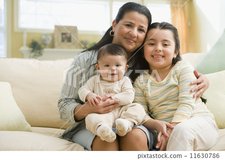 Hispanic grandmother and grandchildren on sofa 11630786