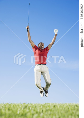 African man cheering on golf course African man cheering on golf course 11630802