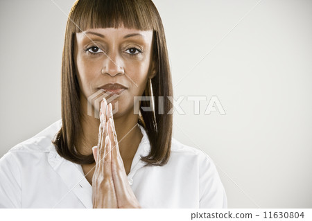 African woman with hands pressed together African woman with hands pressed together 11630804