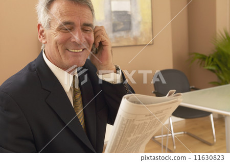 Hispanic businessman talking on cell phone 11630823