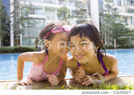 Asian sisters getting out of swimming pool 11630827