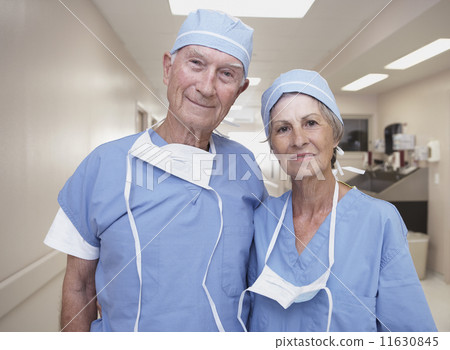 Senior male and female doctors wearing scrubs in hospital 11630845