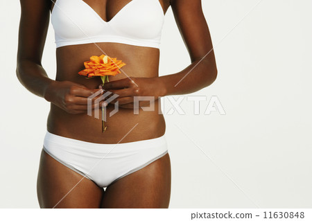 African woman wearing underwear and holding flower African woman wearing underwear and holding flower 11630848
