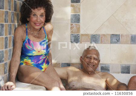 Multi-ethnic senior couple in hot tub 11630856