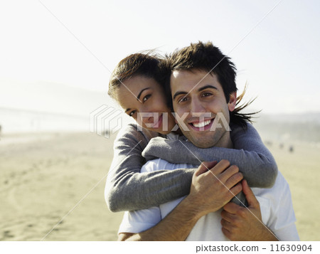 Multi-ethnic couple hugging 11630904