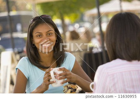 African teenaged girl holding coffee mug 11630955