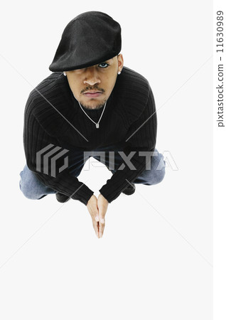 High angle view of African man crouching High angle view of African man crouching 11630989