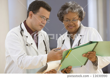 Two doctors reading charts 11630990
