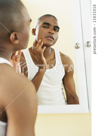 African man looking in mirror African man looking in mirror 11631018