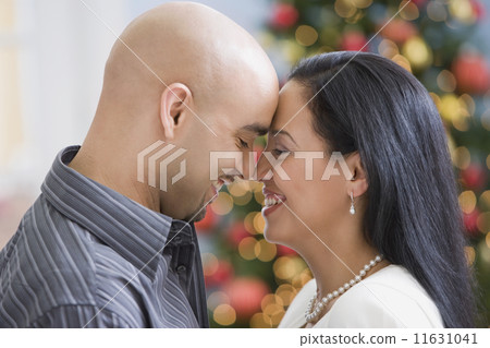 Hispanic couple touching noses Hispanic couple touching noses 11631041